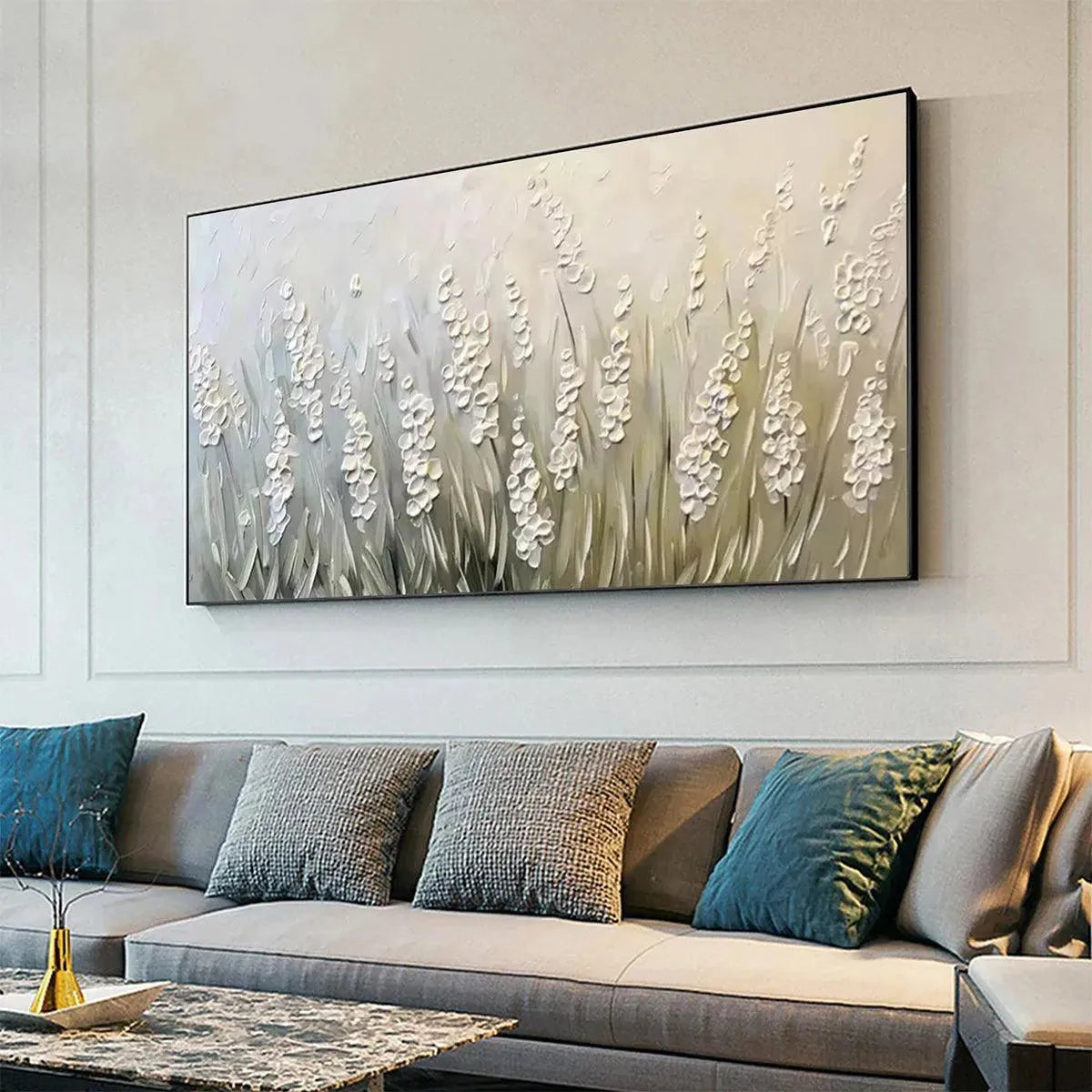 Textured white floral impasto painting on panoramic canvas, displayed above a gray sofa.