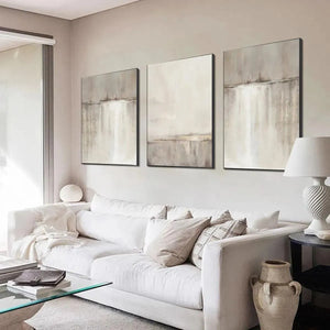Abstract waterfall triptych: 3 minimalist paintings with beige, grey, white tones and gold frames.
