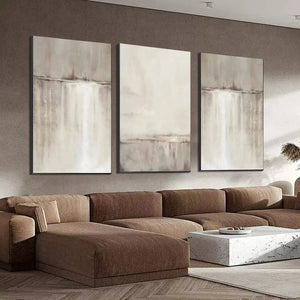 Abstract waterfall triptych: 3 minimalist paintings with beige, grey, white tones and gold frames.