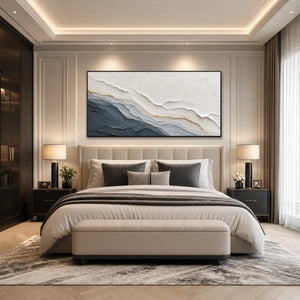 Textured grey and gold abstract landscape painting above modern bed