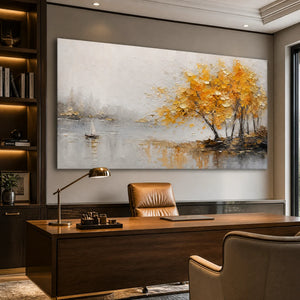 Autumn lake tree wall art with golden impasto trees and sailboat reflections above a modern office desk.