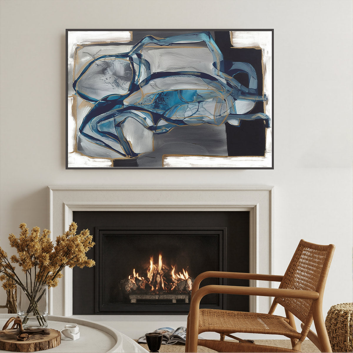 Abstract painting above a fireplace in a living room with a wicker chair.