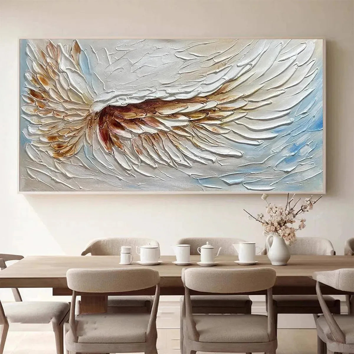 Textured white and gold angel wing painting by Liam O'Connell, horizontal impasto art on dining room wall. Detailed feathers.