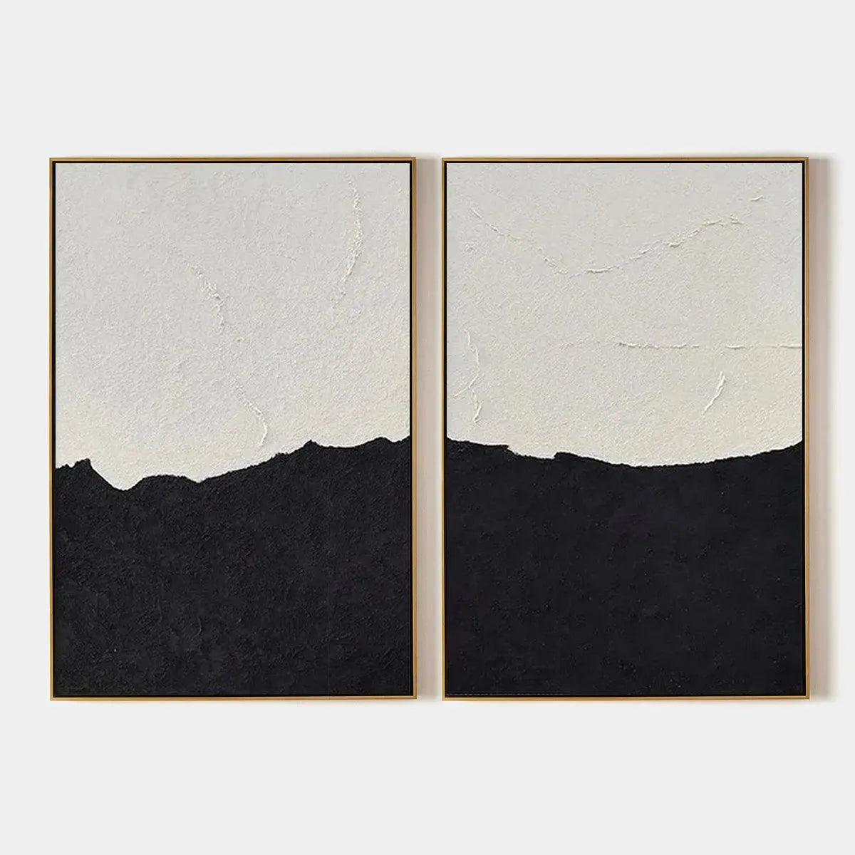 Black & white abstract landscape diptych by Liam O'Connell. Textured wall art with black and white paint, gold frame.