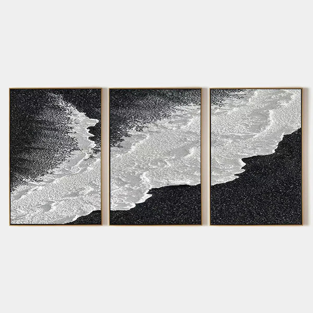 Liam O'Connell's black and white ocean triptych, abstract art with waves and shore, three panels, gold framed.