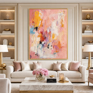 Framed pink abstract oil painting with impasto texture above elegant living room sofa