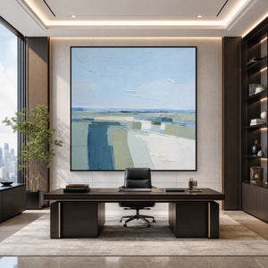 Textured abstract coastal landscape painting in blue, green and white above modern office desk