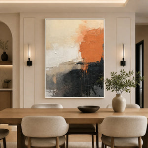 Modern vertical abstract wall art with coral, black and neutral textured tones in a white frame displayed in a refined dining room.