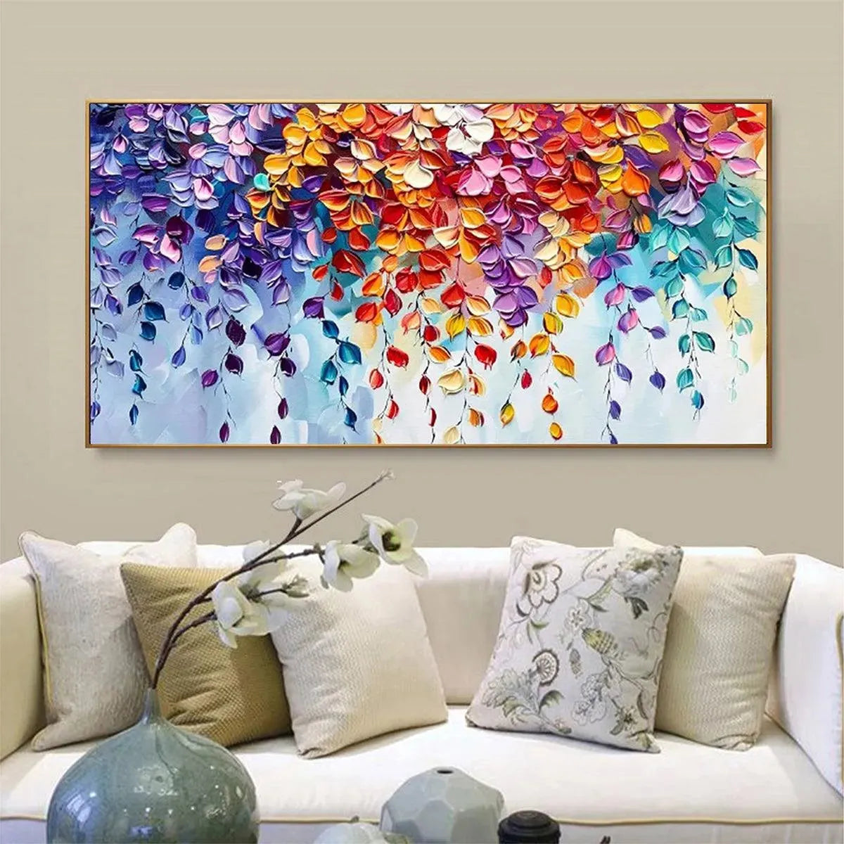 Textured impasto art, vibrant cascading leaves in a gold frame over a white living room sofa.