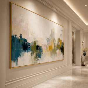 Textured abstract cityscape painting with teal, white, and gold tones in a gold frame