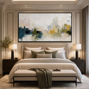 Textured abstract cityscape wall art in beige, blue and gold above a modern bed