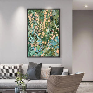 ENCHANTED GARDEN painting by Elodie Dubois: Abstract floral art with green, blue, peach hues, framed, above a gray sofa.
