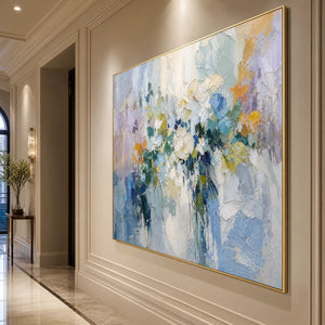 Large abstract floral textured oil painting in blue, lavender and gold on a beige wall