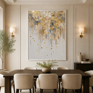 Gold leaf drip abstract painting with textured white, gray and gold finish displayed in a refined dining room.
