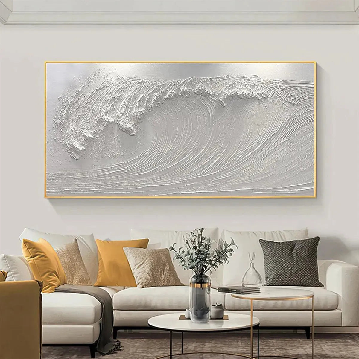 Liam O'Connell's white impasto wave painting in gold frame displayed in a modern living room above a sofa.