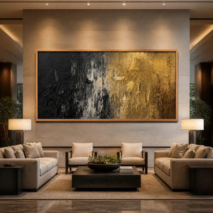 Black and gold textured abstract wall art in a wood frame displayed in a luxury hotel lobby.