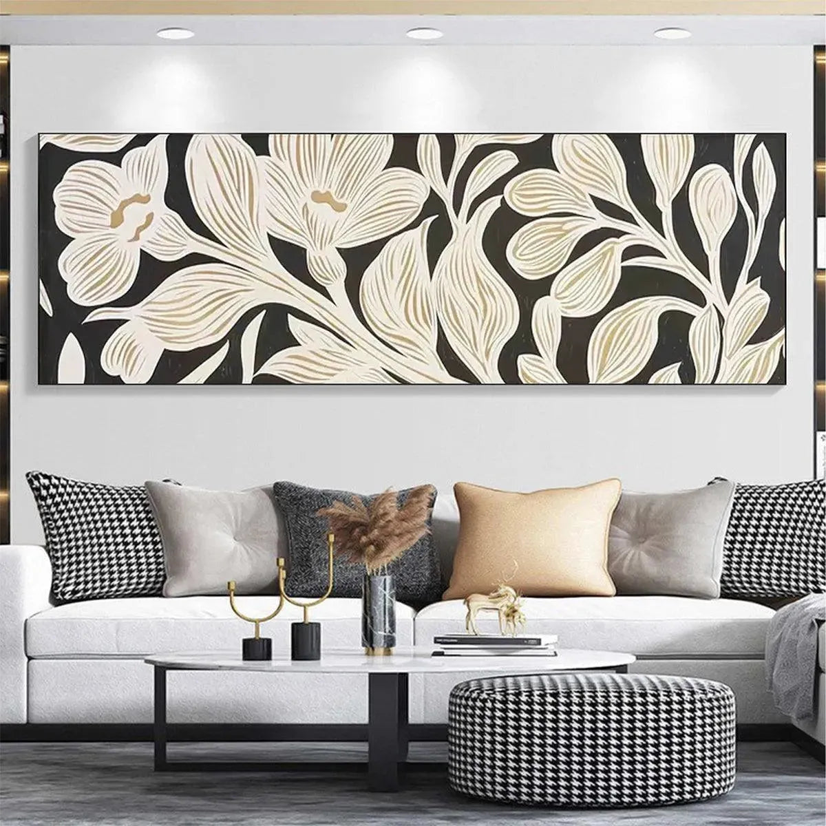 Panoramic wall art with cream and gold floral design on black background, displayed in modern living room.