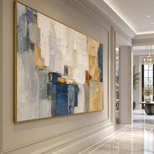 Textured abstract cityscape impasto painting with blue, white and gold tones in a gold frame