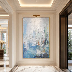 Textured abstract coastal city painting in blue, white and gold on a hallway wall