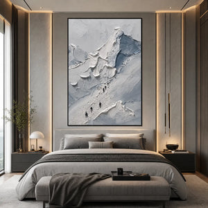 Textured abstract mountain climbers wall art in gray and white above a modern bed
