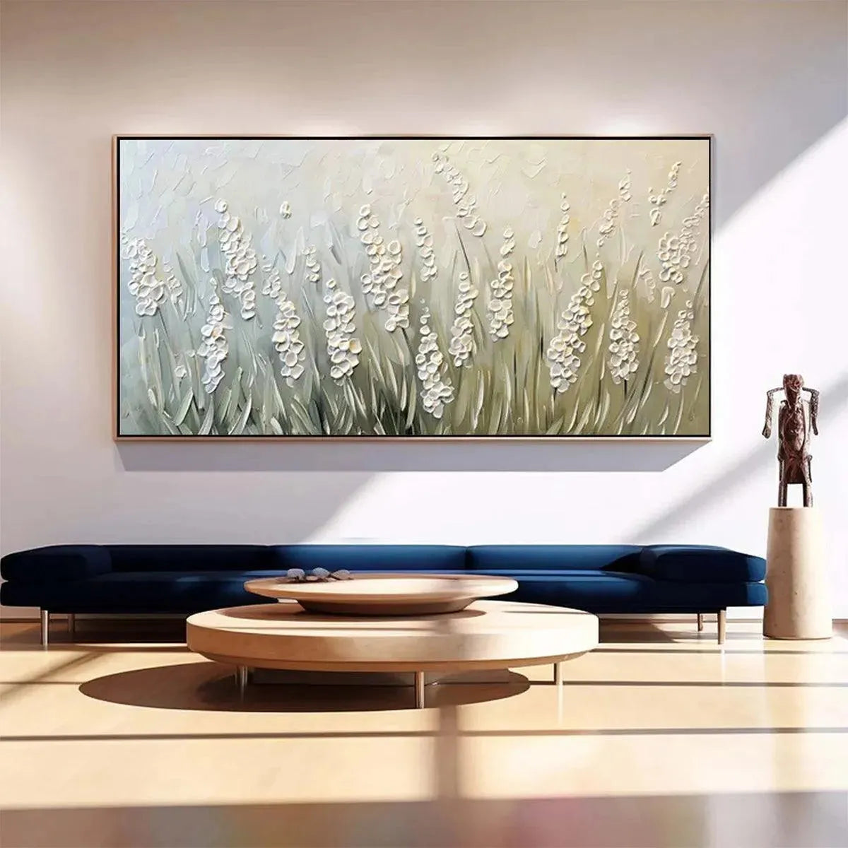 Modern living room featuring a large textured green and white floral meadow painting above a navy sofa.