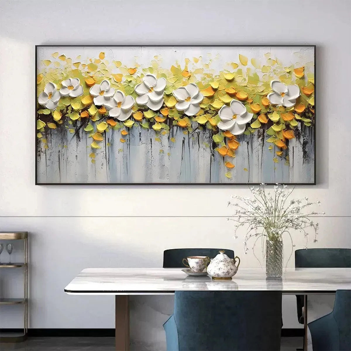 White Magnolias textured floral painting with 3D white petals and yellow foliage, black framed, in a modern dining room.