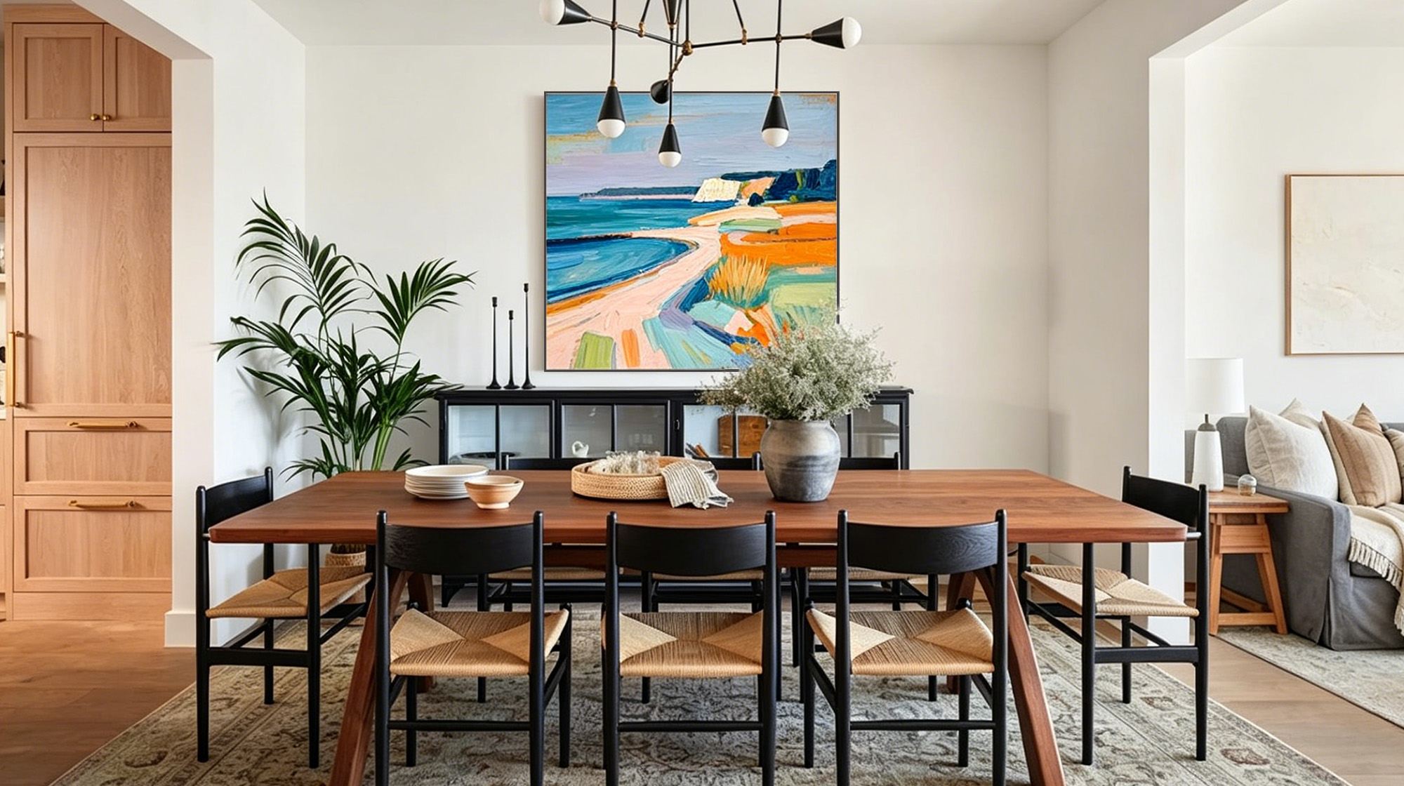 Modern dining room with a colorful coastal painting above a wooden table