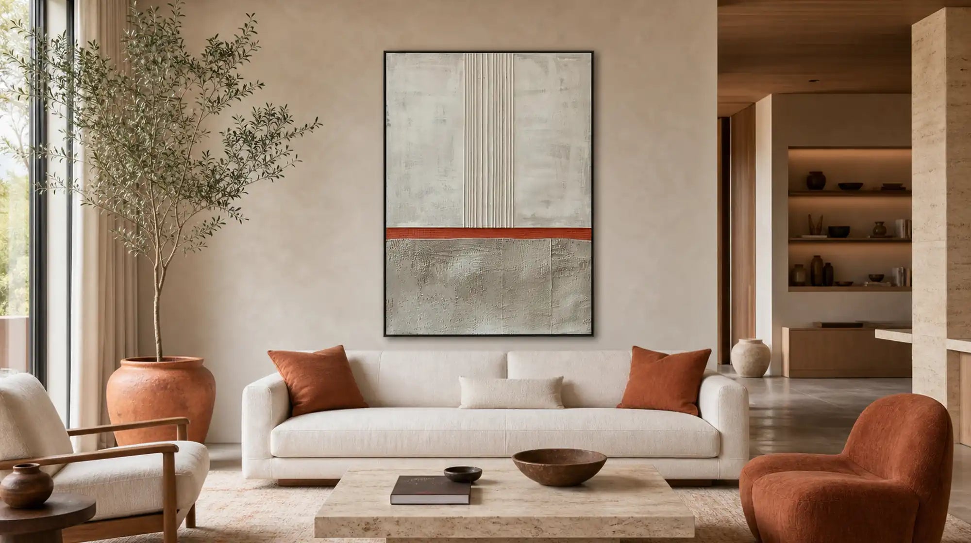 Neutral abstract canvas with a rust-orange stripe above a white sofa.