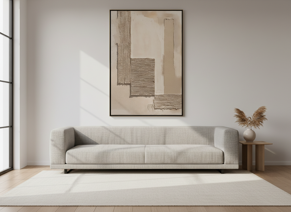 Textured abstract wall art above a sofa in a bright living room, showing balanced proportion and centered placement