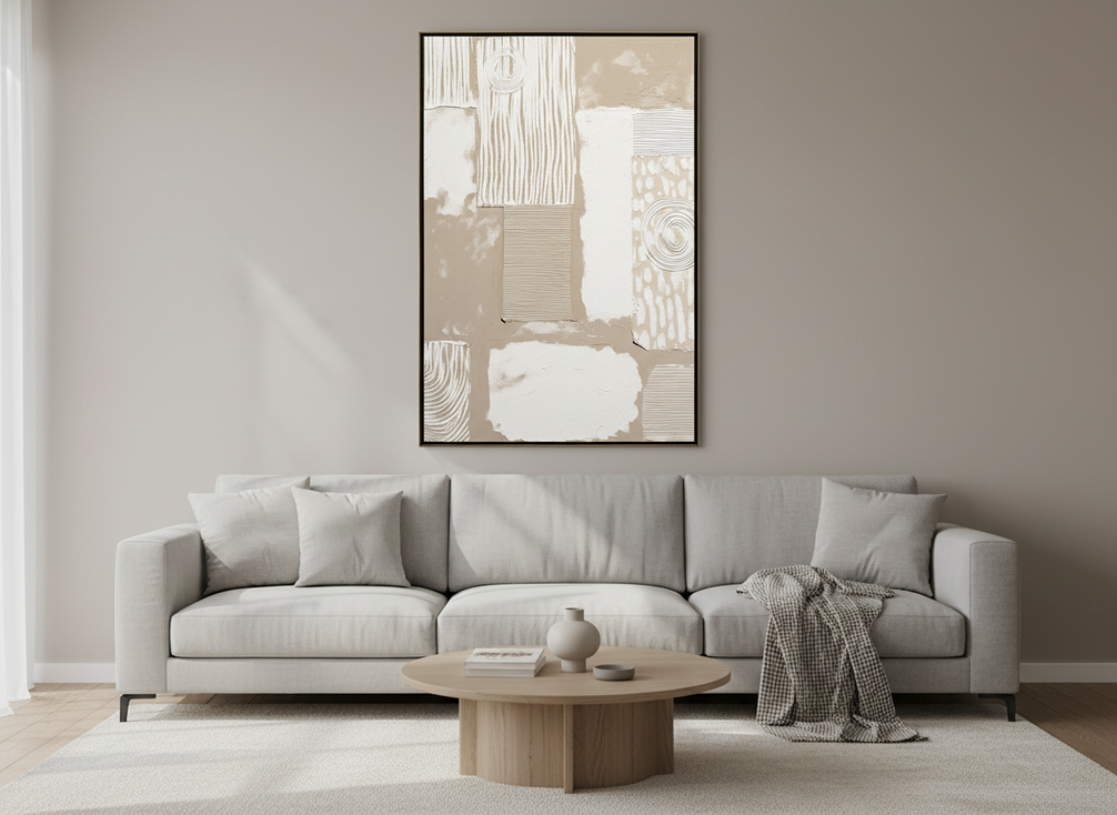 Large textured abstract painting above a sofa in a modern living room, showing proper width proportion and low hanging height