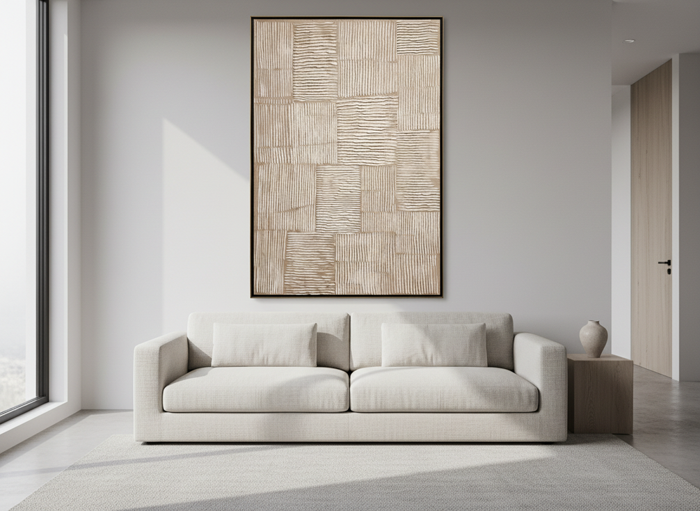 Textured wabi-sabi abstract wall art above a sofa in a calm living room with soft side light