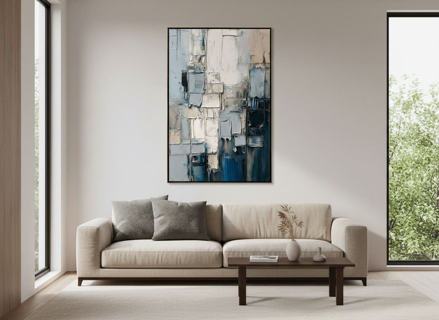 Heavily textured abstract wall art in a bright living room with side daylight creating visible shadows