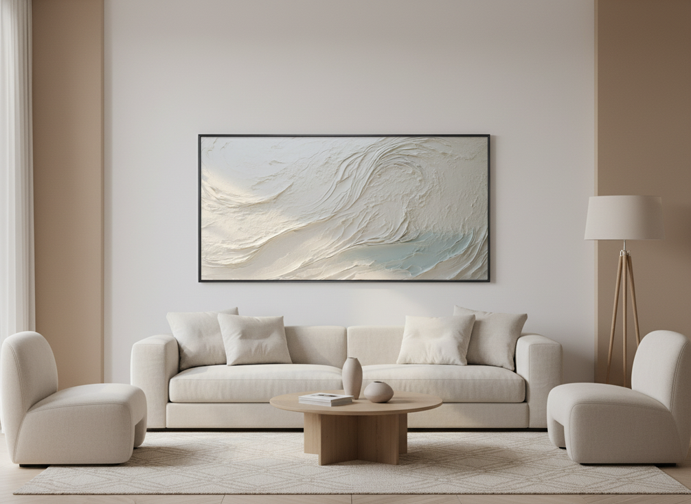 White textured abstract wall art in a minimalist living room above a low sofa, with soft daylight revealing raised surface details