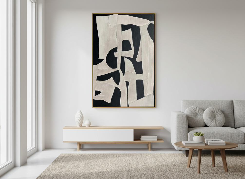 Black-and-white abstract wall art in a bright modern room with clean contrast and subtle texture
