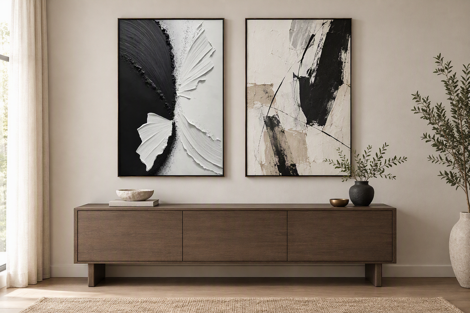 Two distinct abstract paintings arranged as a balanced pair above a modern console