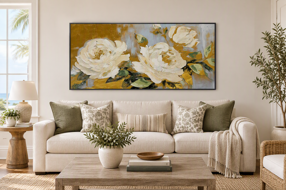 Large framed wall art anchoring a bright vacation-rental living room with a sofa, rug, and window visible around it.