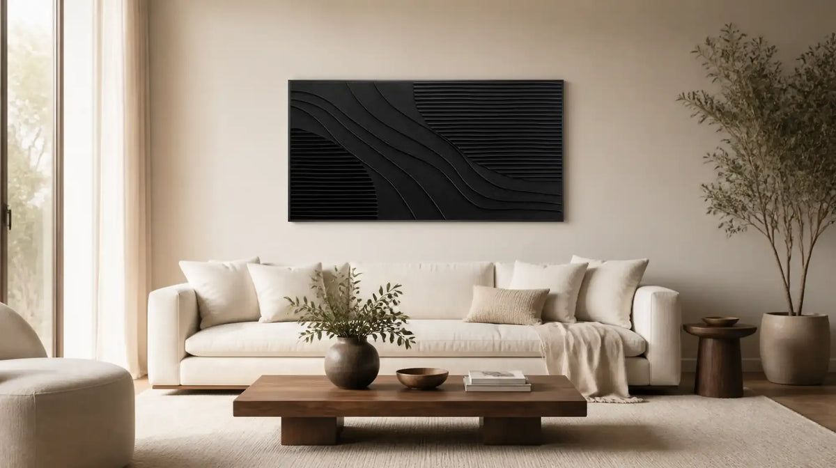 Black textured wall art above a beige sofa in a bright living room