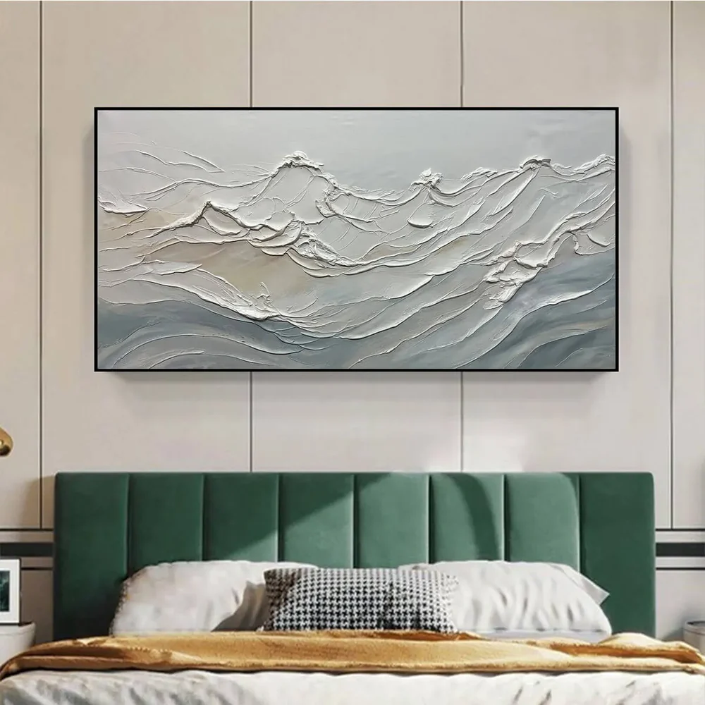 Wide gray and white textured mountain landscape painting above emerald bed, showing raised ridges and soft layers in calm bedroom.