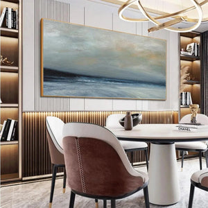 Liam O'Connell's Twilight Coast panoramic painting in muted blues and grays above a dining table.
