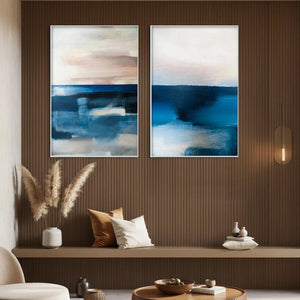 Set of 2 vertical abstract seascape paintings in blues and pinks by Willow Davies, displayed in a living room.