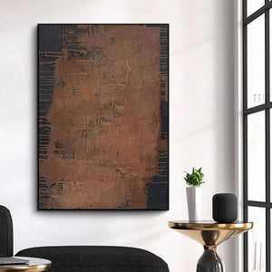 Vertical abstract painting "Rustic Texture" in brown hues with textured surface and black frame, showcased in a room setting.