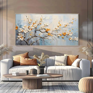 Elodie Dubois' 'Spring Blossoms': textured white & gold floral painting on blue in modern living room setting.