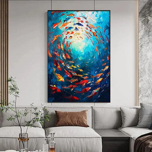 CORAL REEF DANCE painting by Yan Nan Li, colorful fish artwork in a gold frame, enhancing the living room's underwater theme.