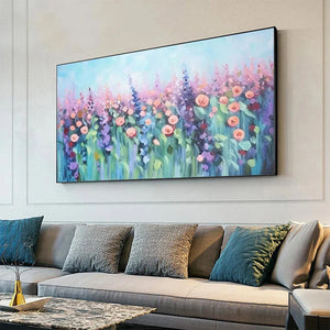 Elodie Dubois' 'Pastel Meadow' artwork, an impressionistic floral painting above a grey sofa in a modern living room.
