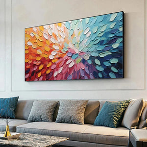 Textured impasto abstract painting "Rainbow Burst" in a modern living room over gray sofa.