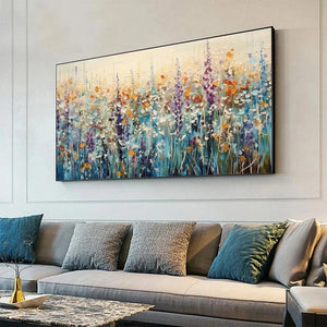 WILD MEADOW: Isabella Rossi's impasto painting of a vibrant wildflower meadow above a grey sofa.