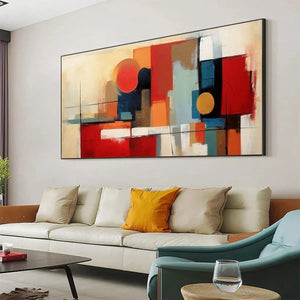 Modern living room featuring Urban Geometry abstract painting with red, gold & blue geometric design above beige sofa.