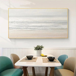 Liam O'Connell's Tranquil Coast minimalist coastal painting, textured beige and grey sea, framed in gold, lifestyle setting.