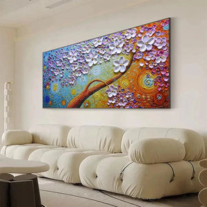 Lilac Dream textured floral painting with white blossoms and multicolored swirls above cream sectional sofa.