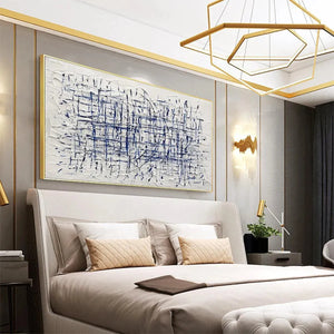 Javier Ramirez BLUE GRID abstract painting: textured white with blue lines, framed artwork, above a bed.